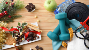 A mix of good and bad habits—treats beside workout gear, weights, and fruit—showing the balance between indulgence and maintaining a healthy lifestyle.